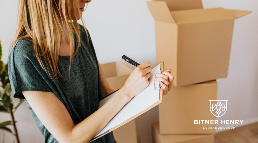 Someone does a home inventory, with a clipboard and boxes. The Bitner Henry logo is in the bottom right.