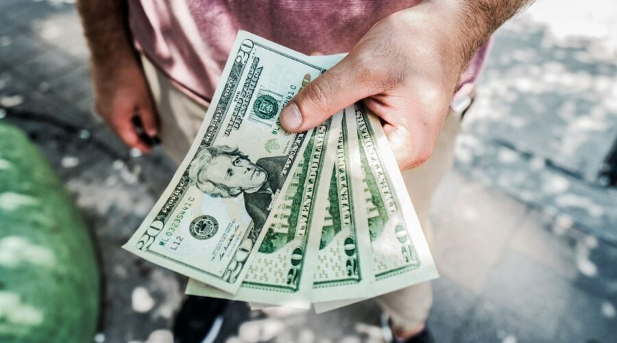 Man wearing a rt-shirt holding money