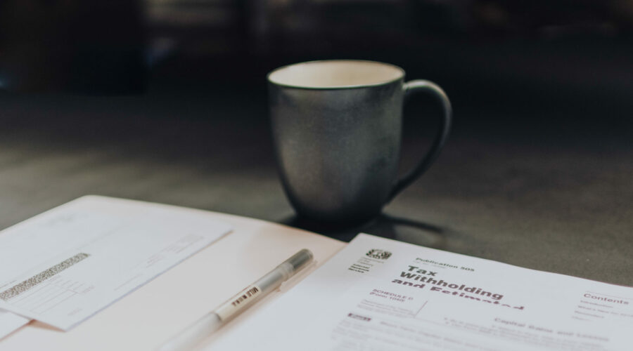 Coffee cup with paperwork