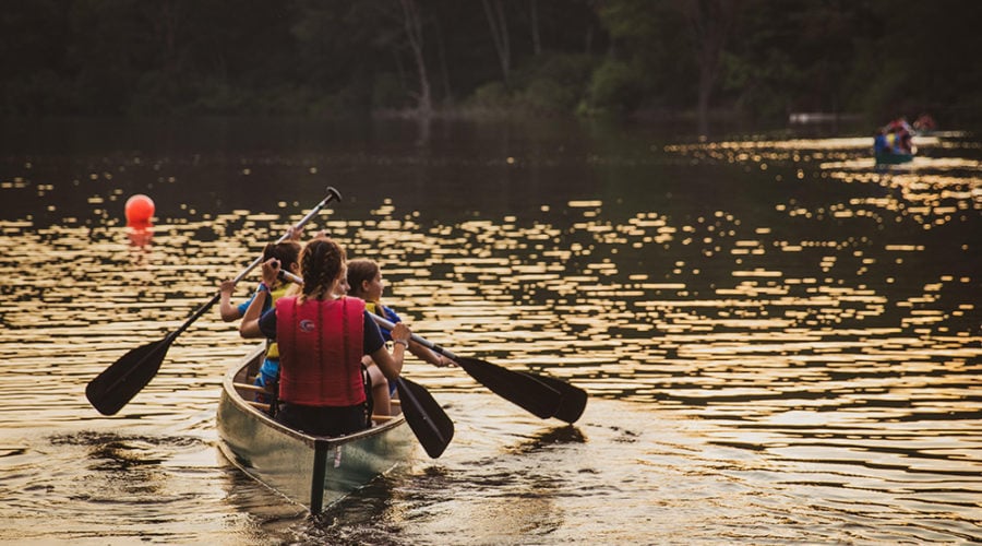 kids paddling in a canoe