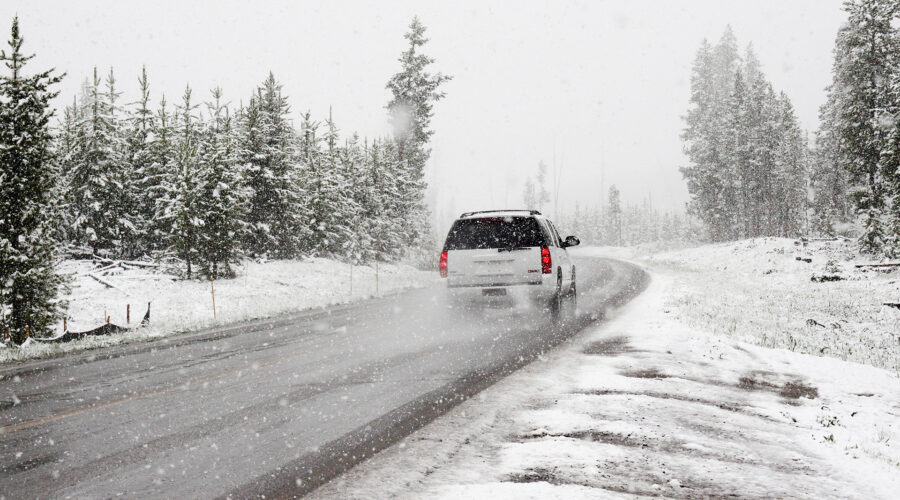 suv drives on snowy road