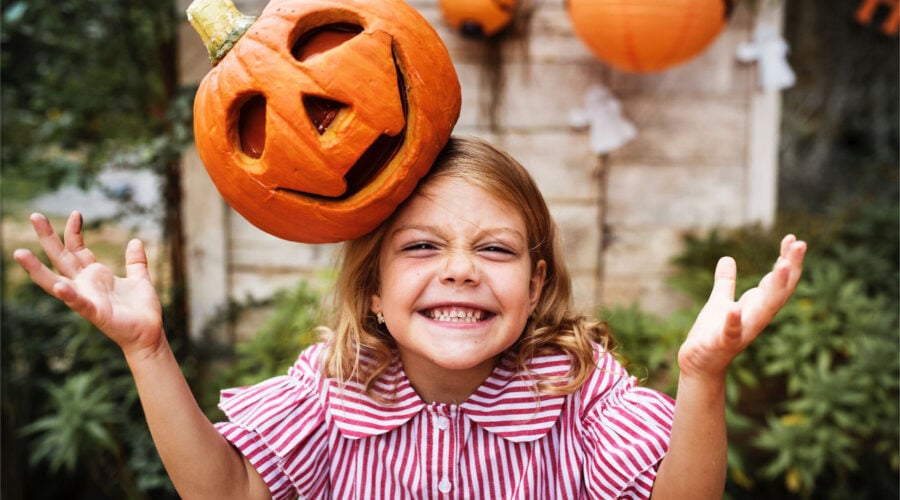 girl with carved pumpkin