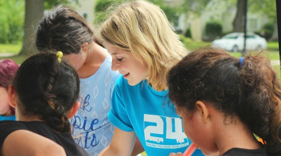 Blonde woman wearing a blue t-shirt while volunteering