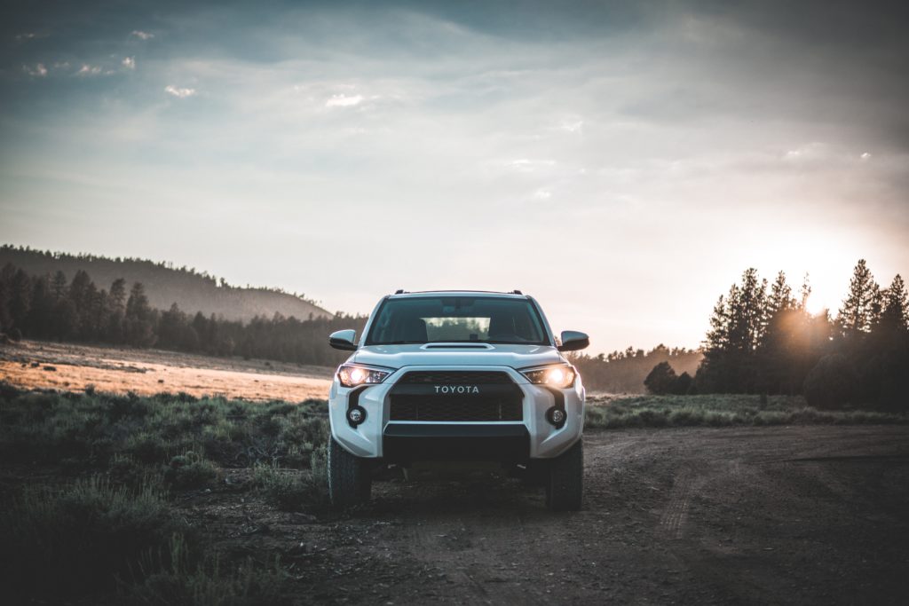 White Toyota truck parked on a dirt road