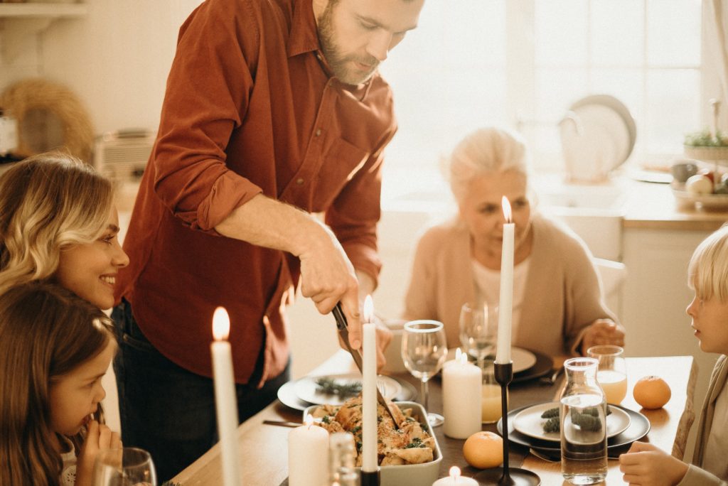 Family sitting at the table together eating dinner 