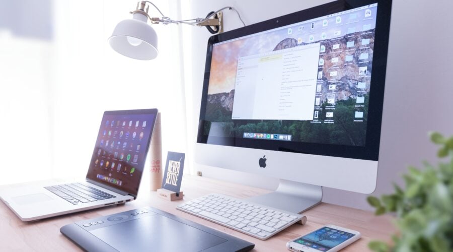 Apple Desktop Computer on desk with laptop