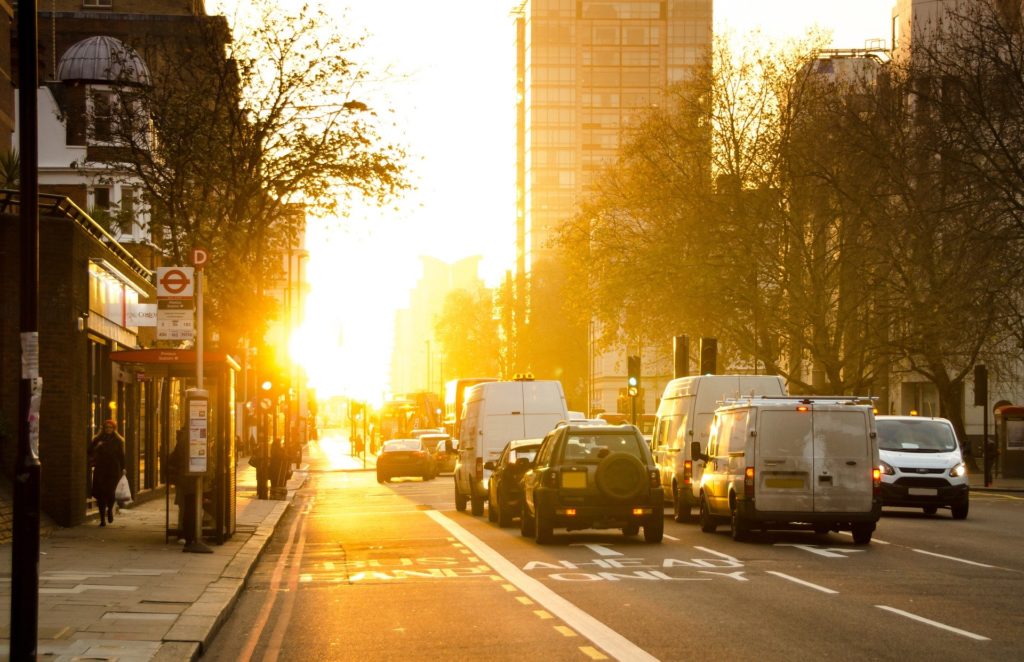 Cars sitting in traffic at sunset 