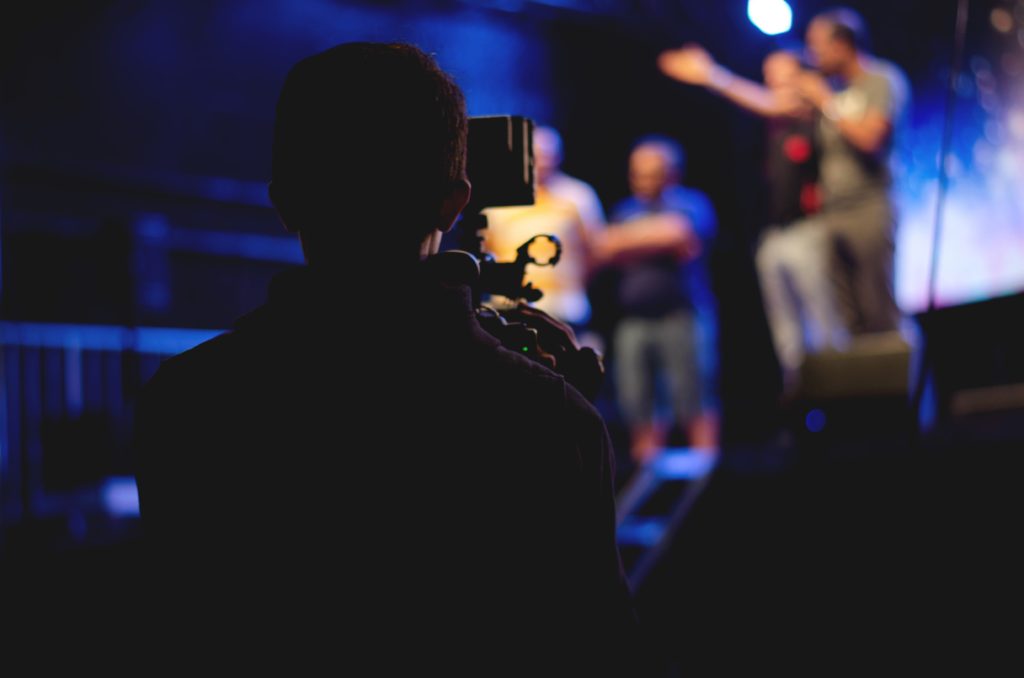 people on stage with camera