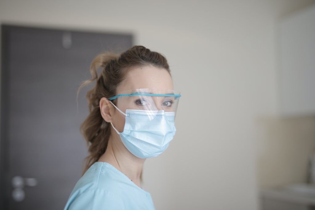 Nurse wearing a mask and face shield