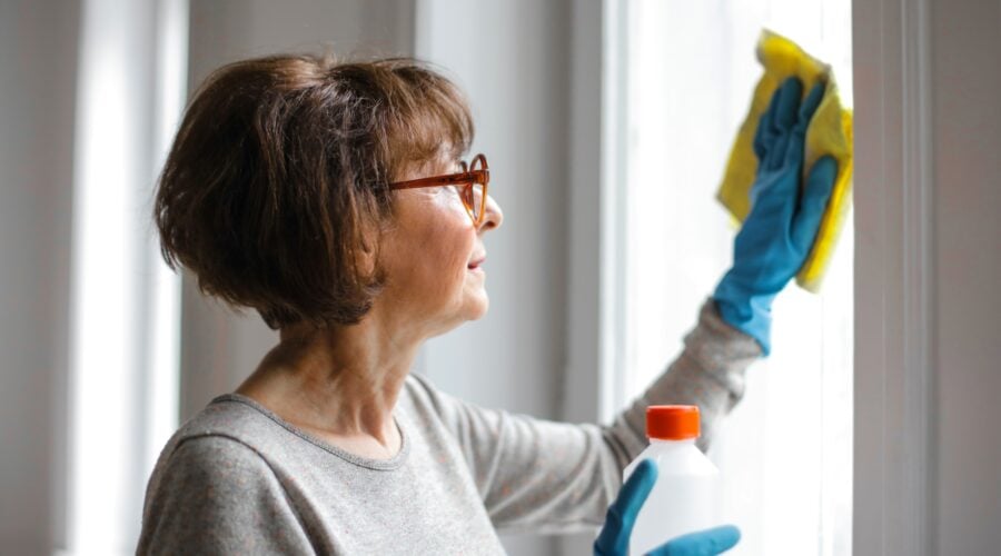 Woman cleaning wearing gloves