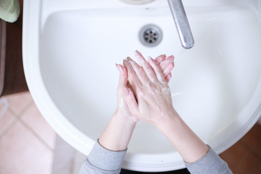 Woman washing hands in sink