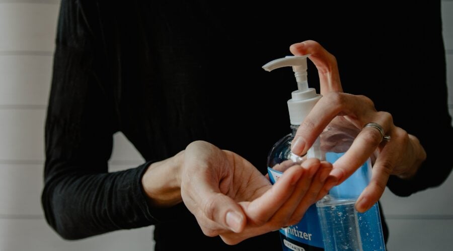 Woman using hand sanitizer