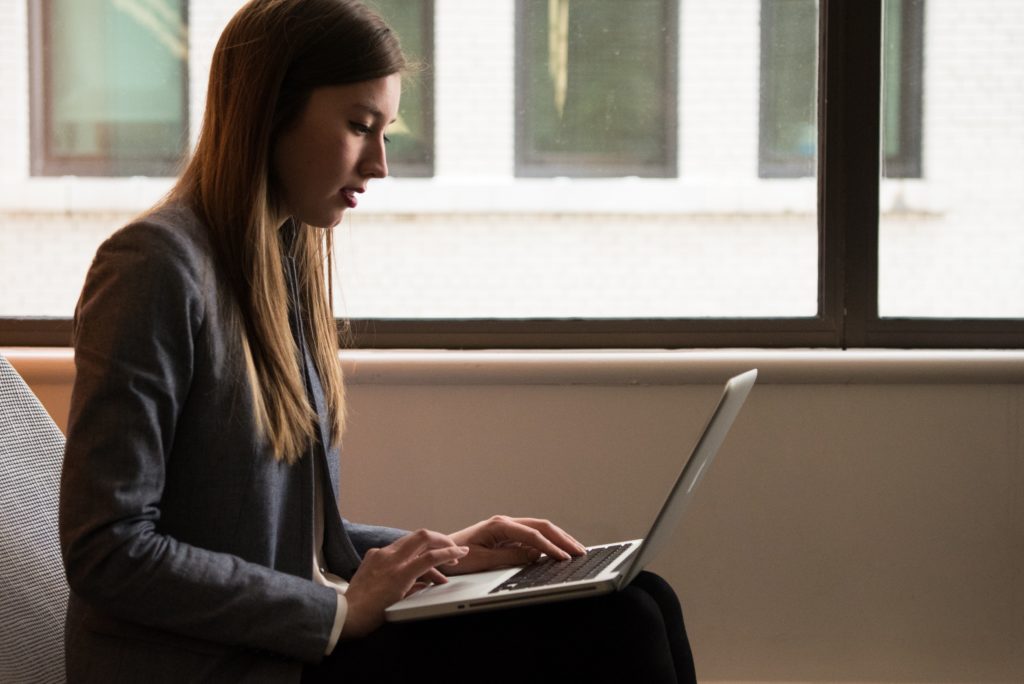 Woman typing on laptop computer