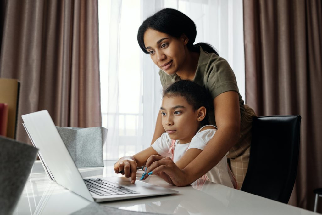 Mother helping child with school