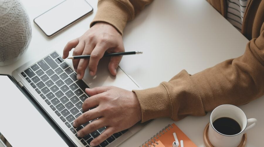 Man typing on laptop computer