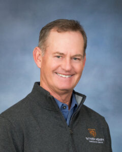 Dan Burrell smiles at the camera