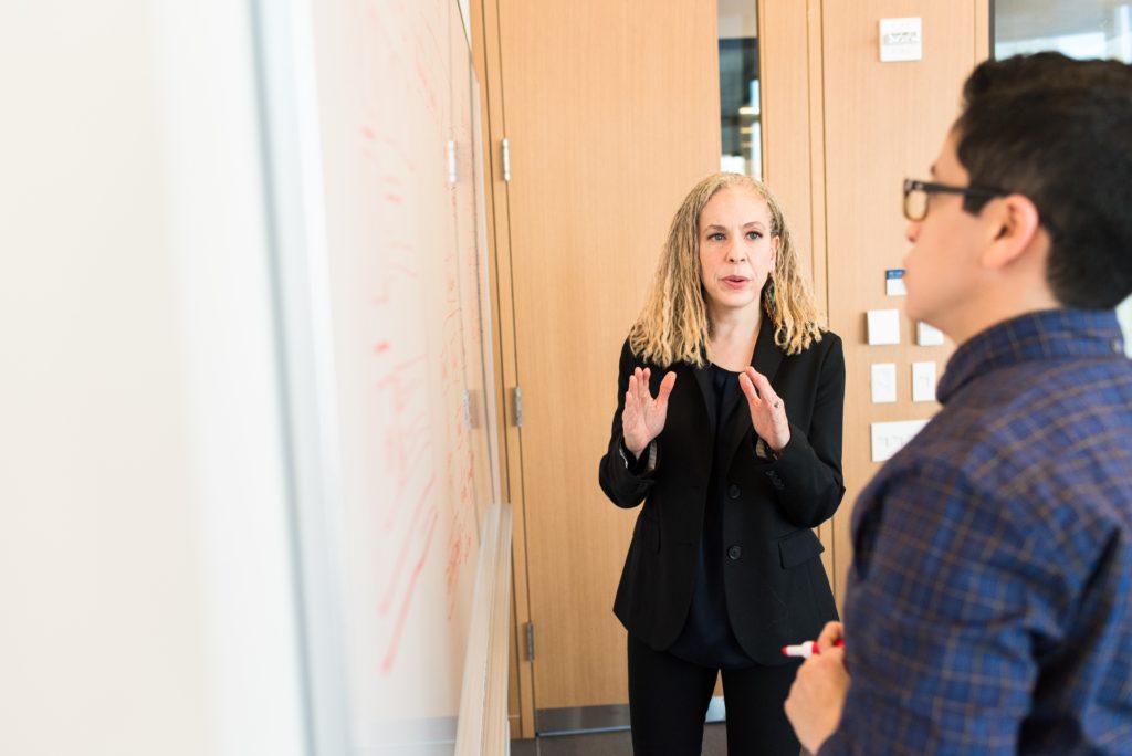 Man and woman meeting at whiteboard