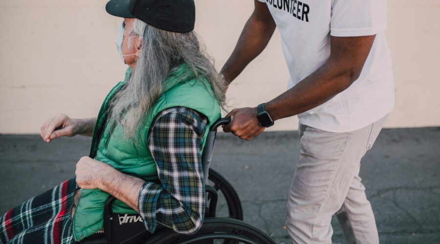 Volunteer and man in wheelchair