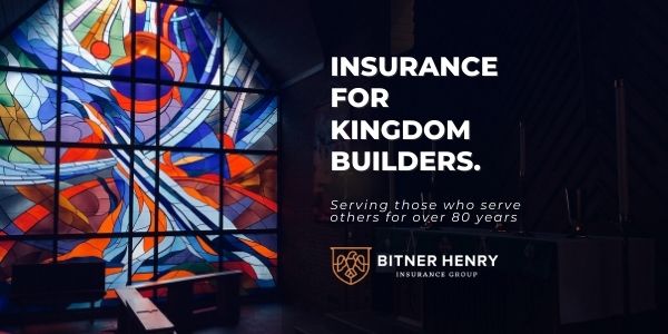 Stain glass in church with text of 'Insurance for Kingdom Builders.'