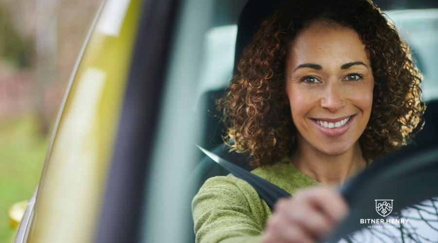 A safe, screened driver drives along the road. The Bitner Henry logo is on the bottom right.
