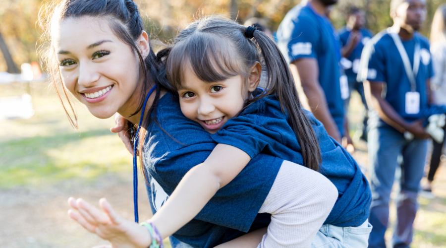 Female camp counselor playing with child