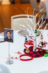 A table decorated with a white tree centerpiece and a picture of Todd Savageau