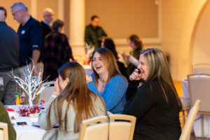 Friends laugh at the table