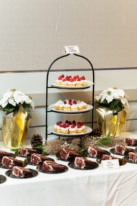The dessert table, stacked with cupcakes and red velvet cake