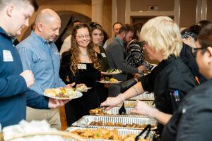 People get food from the line of caterers