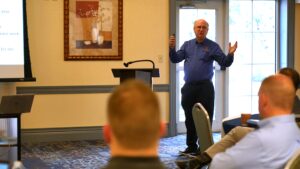 Steve gives a State of the Agency speech while people listen raptly