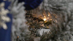 A warm tree light through the frosted Christmas tree
