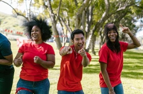 Church People Three happy employees in red shirts smile at the camera