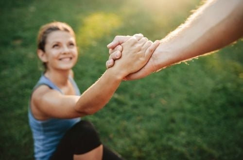 Someone helps someone else up A helping hand helps up a woman