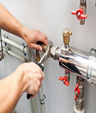 Bitner Website header images - vertical - wordpress (1) A plumber fixes two pipes with a wrench