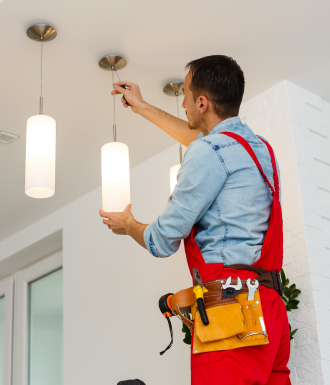 Bitner Website header images - vertical - wordpress (2) An electrician puts up a light fixture