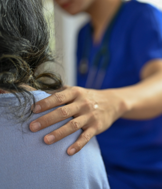doctor and patient a doctor extends a comforting hand to a patient in a partial hospitalization program