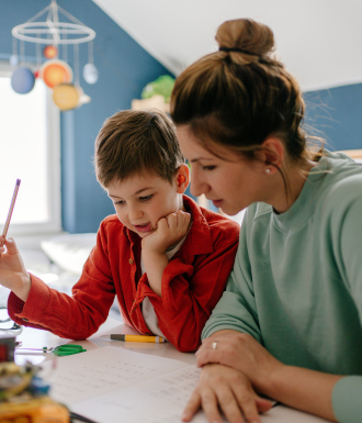 School Bus (4) A mom and son look down at their homeschool schoolwork