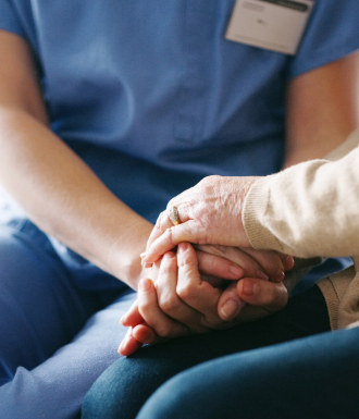 Hand-holding A detox nurse holds her patient's hand
