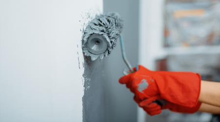 Painting a wall with a roller as a painting contractor