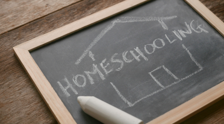 A chalkboard with "homeschooling" written on it for a co-op