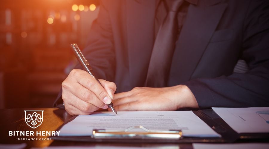 A man signs professional liability papers for his sober home