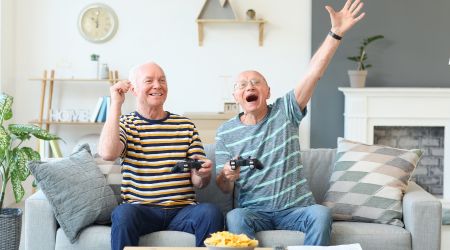 Two happy recovery patients celebrate playing video games