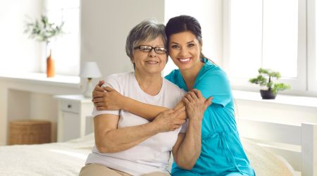 A nurse hugs a recovery patient