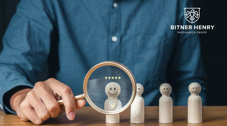 HR examines happy employees. The Bitner Henry logo is in the top right.