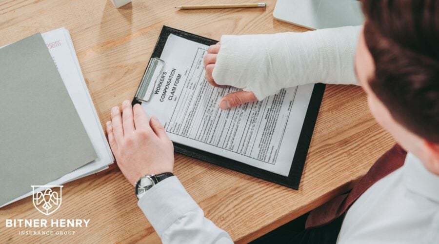someone files workers' compensation with their hand in a cast. The bitner-henry logo is in the bottom-left