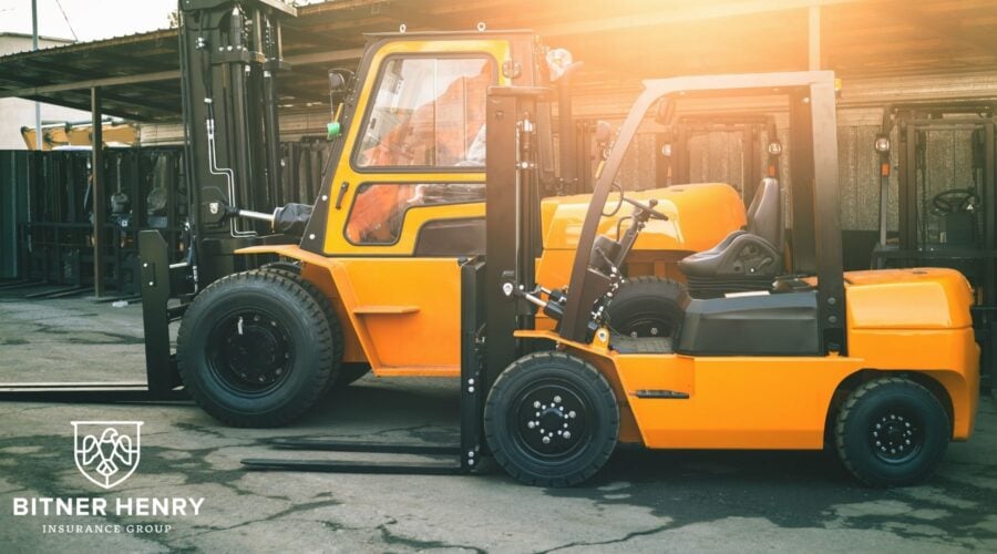 Two safe forklifts drive through a warehouse. The Bitner Henry logo is in the corner.