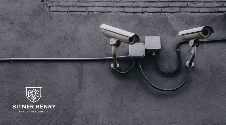 cameras watching from a wall, the bitner henry logo is in the bottom left
