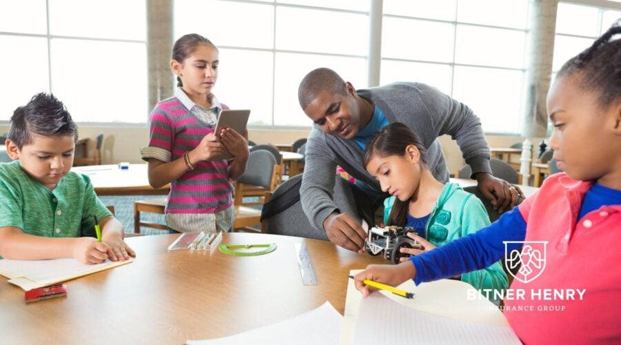 Children at an afterschool program with teachers. The Bitner Henry logo is in the bottom right.