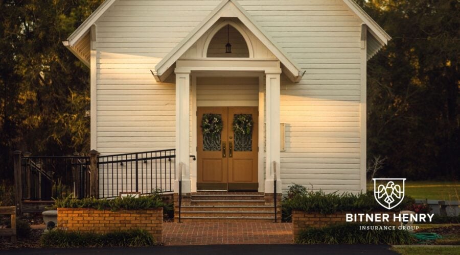 A small church sits by the forest. The Bitner Henry logo is in the bottom right.
