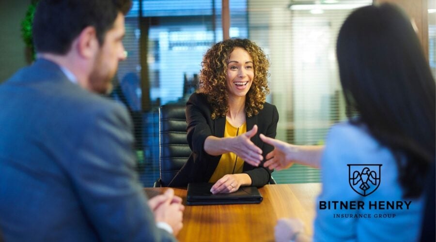 church members conduct an in-person interview with a potential volunteer. The Bitner Henry logo is in the bottom right.